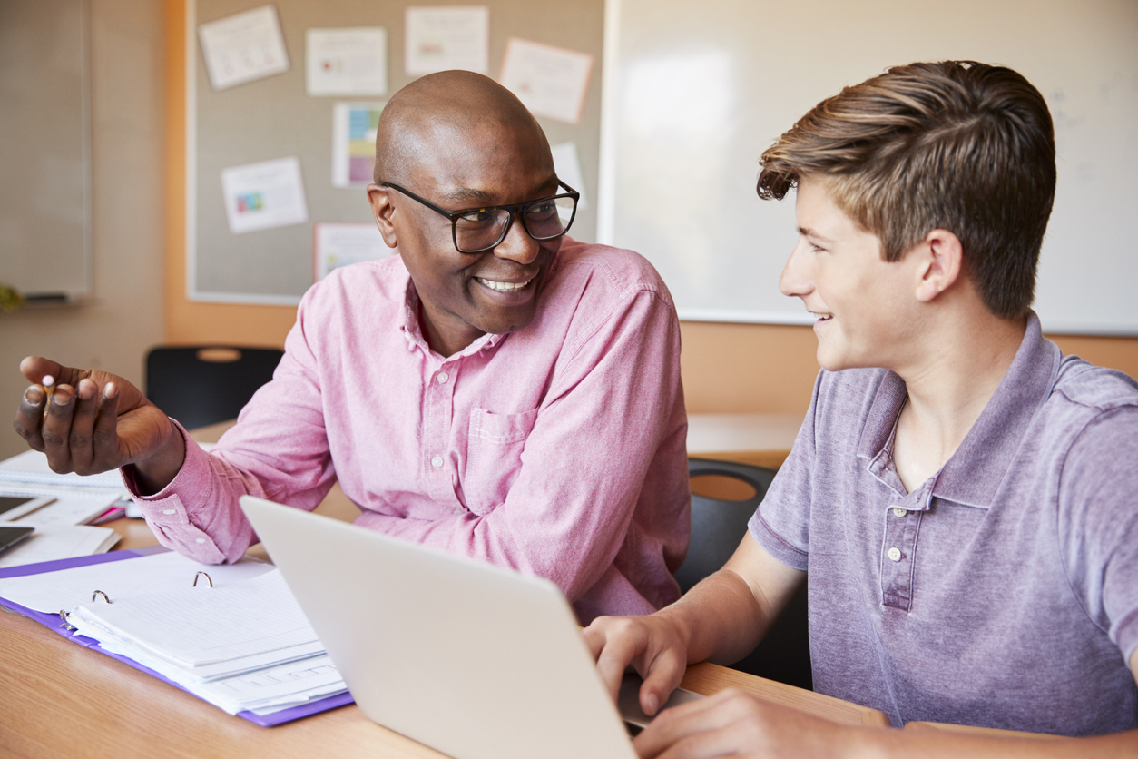 Man tutoring teen boy